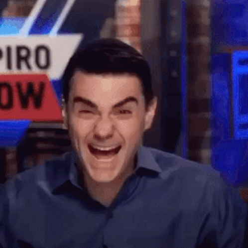 Man In Blue Shirt Laughing In Front Of Piro Now Sign GIF