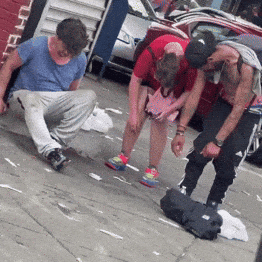 Man In Blue Shirt Looking Down On Sidewalk GIF