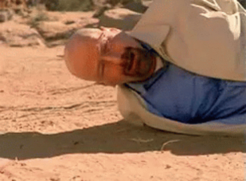 Man in Blue Shirt Lying on Sand