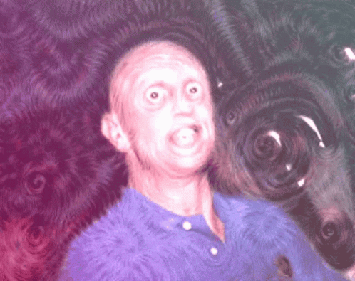 Man in Blue Shirt Making Funny Face on Purple Background