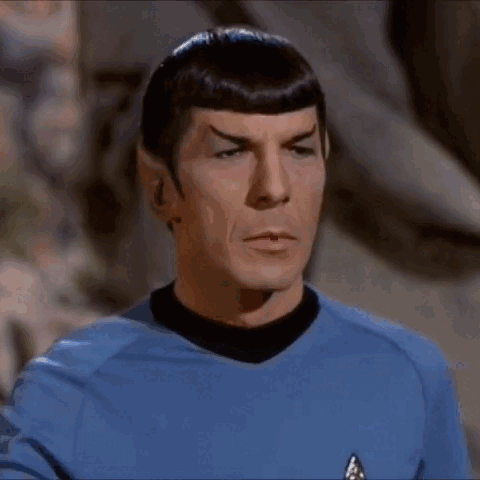 Man in Blue Shirt Making Stop Gesture