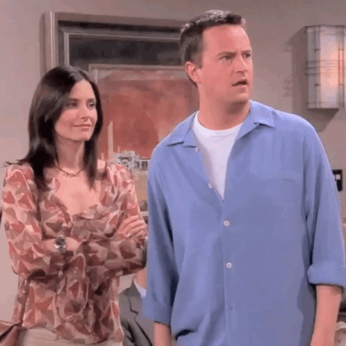 Man in Blue Shirt Next to Woman in Floral Shirt