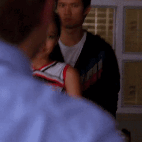 Man in Blue Shirt Next to Woman in Red White and Blue Shirt