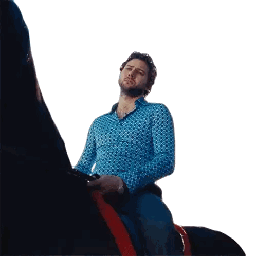 Man in Blue Shirt on Black Horse