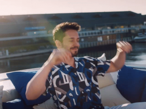 Man In Blue Shirt On Boat Arms Outstretched GIF