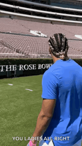 Man in Blue Shirt on Football Field