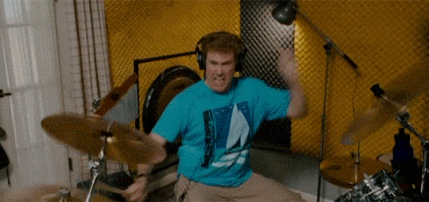 Man in Blue Shirt Playing Drums