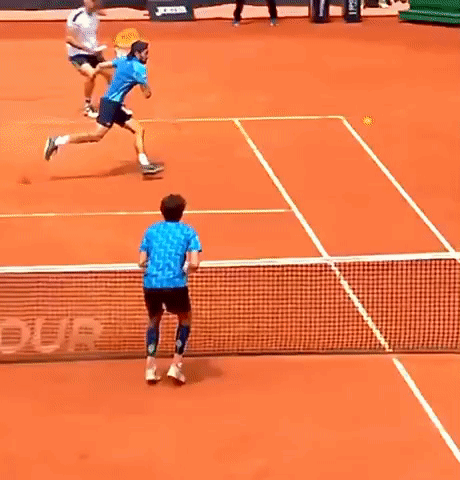 Man in Blue Shirt Playing Tennis