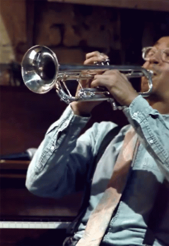 Man in Blue Shirt Playing Trumpet
