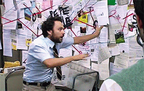 Man In Blue Shirt Pointing At Bulletin Board GIF