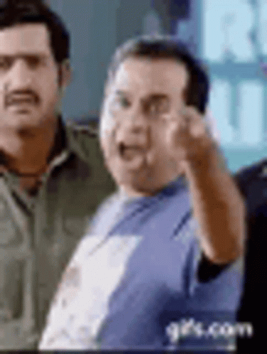 Man In Blue Shirt Pointing At Camera Next To Another Man GIF