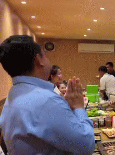 Man in Blue Shirt Praying