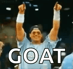 Man in Blue Shirt Raising Arms With Goat