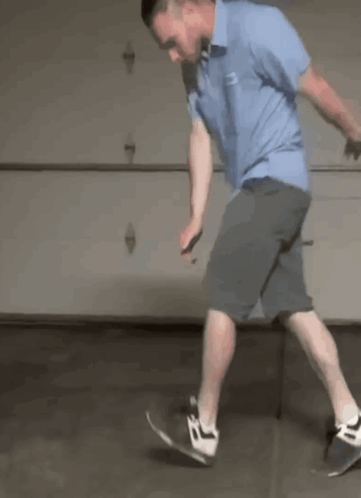 Man in Blue Shirt Riding Skateboard