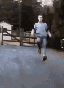 Man in Blue Shirt Running