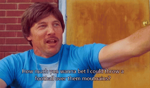 Man in Blue Shirt Saying How Much You Wanna Bet I Could Throw a Football Over Them Mouthains