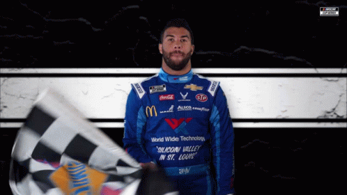 Man in Blue Shirt Saying Silicon Valley in St. Louis Holding Checkered Flag