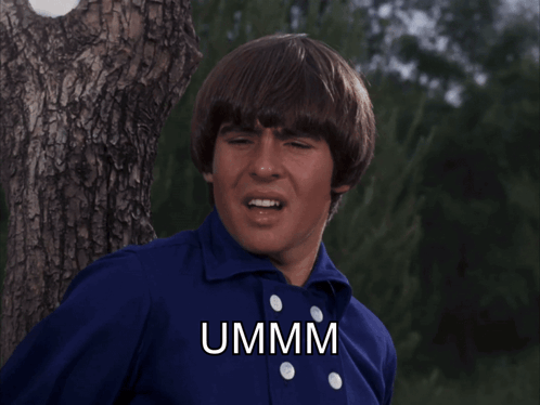 Man in Blue Shirt Says Ummm Beside Tree