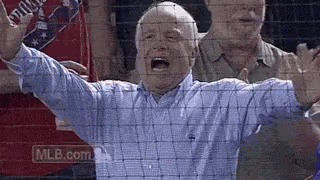 Man in Blue Shirt Screaming at Baseball Game