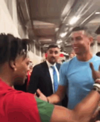 Man In Blue Shirt Shaking Hands GIF