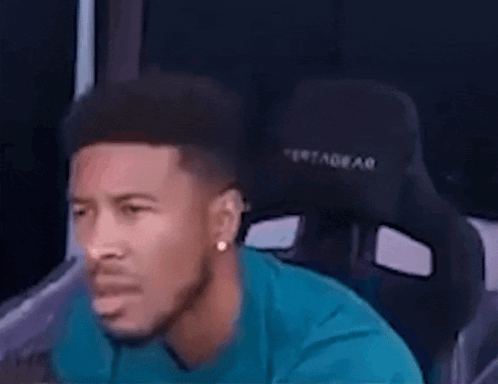Man in Blue Shirt Sitting in Black Chair