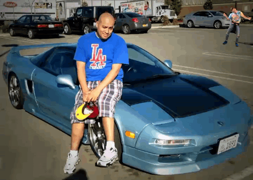 Man In Blue Shirt Sitting On Car Hood GIF