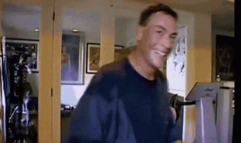 Man in Blue Shirt Smiling and Dancing