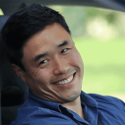 Man in Blue Shirt Smiling and Making Face