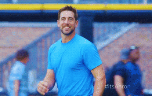 Man in Blue Shirt Smiling at Baseball Stadium