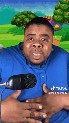 Man in Blue Shirt Smiling at Microphone