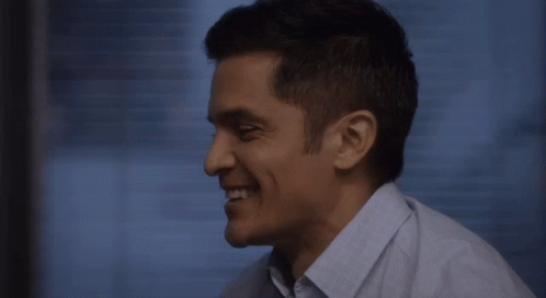 Man in Blue Shirt Smiling Looking Down