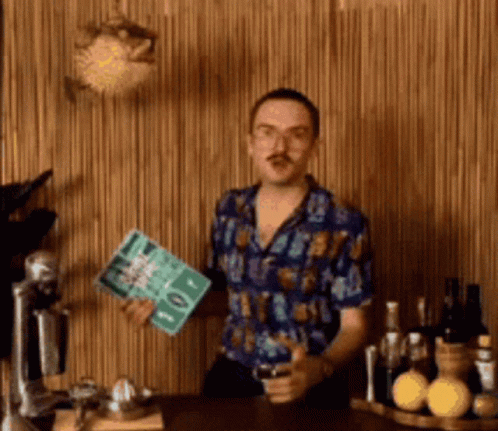 Man in Blue Shirt Standing by Wooden Wall