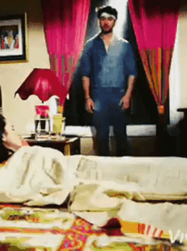 Man in Blue Shirt Standing in Bedroom