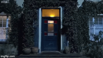 Man in Blue Shirt Standing in Front of Door