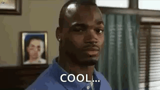 Man In Blue Shirt Standing In Room With Woman Picture GIF