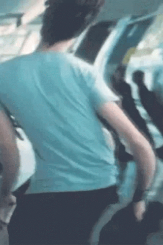 Man in Blue Shirt Standing With Group on Plane