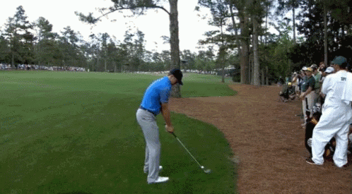 Man In Blue Shirt Swinging Golf Club GIF