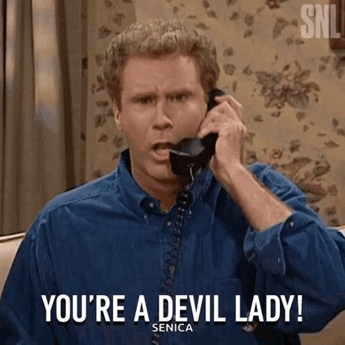 Man in Blue Shirt Talking on Telephone Saying You're a Devil Lady