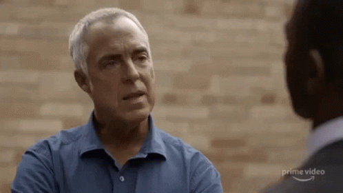 Man In Blue Shirt Talking To Man In Grey Suit GIF