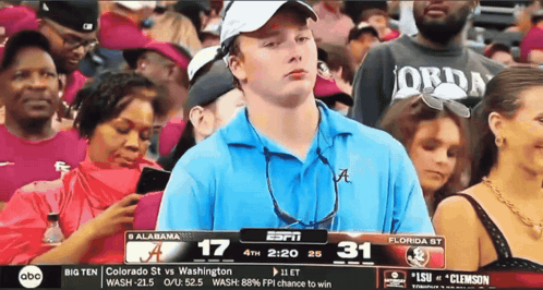 Man in Blue Shirt Watching Alabama vs Washington
