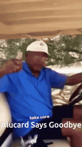 Man in Blue Shirt White Hat Driving Golf Cart Goodbye