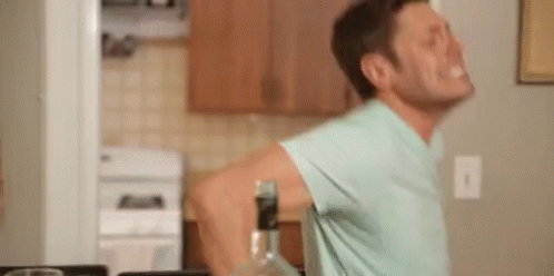 Man In Blue Shirt With Bottle Of Alcohol GIF