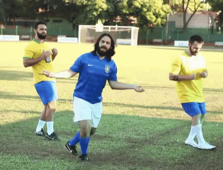Man in Blue Shirt With Brazilian Flag Dancing on Soccer Field