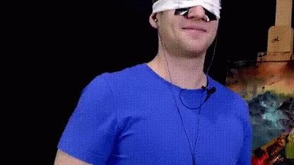 Man in Blue Shirt with Earbuds