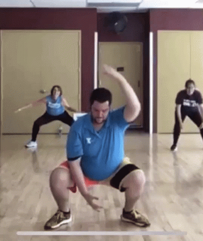 Man in Blue Shirt With Letter Y Squatting