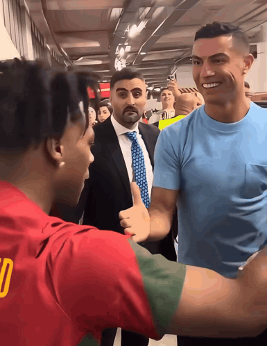Man in Blue Shirt With Number 10 Talking to Another Man