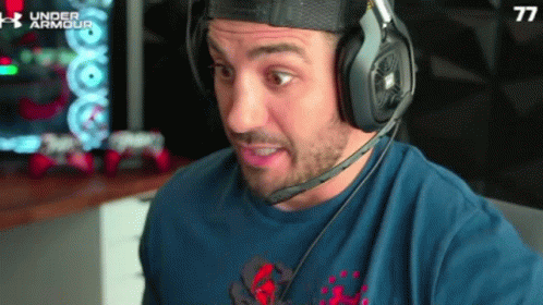 Man in Blue Shirt With Number 77 and Headphones