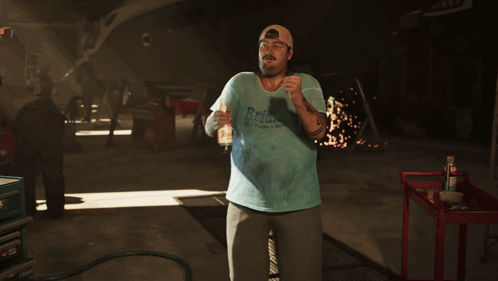 Man in Blue Shirt with RPM in Garage