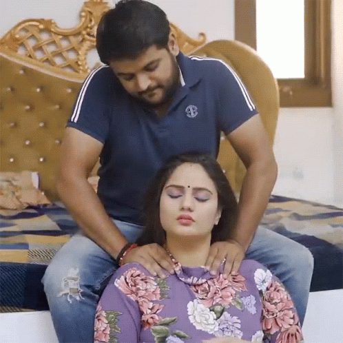Man in Blue Shirt With S Massaging Woman
