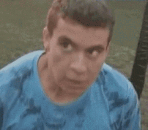 Man in Blue Shirt with Serious Look